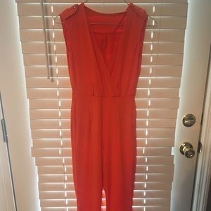Small orange jumpsuit with deep v neckline